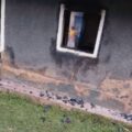 Burnt window frame and wall of a house in Itumbu village, Lugari Sub-County, showing damage from a night arson attack.