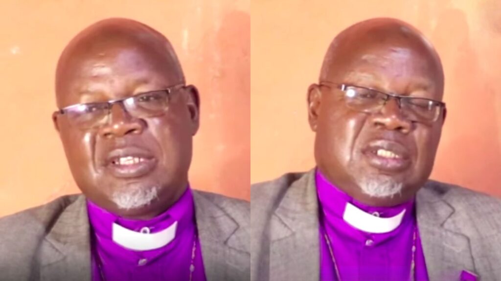 A middle-aged man wearing glasses, a purple clerical shirt, and a grey jacket speaks during an interview, shown in two side-by-side frames against a plain background.