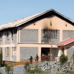 A dormitory building at Utumishi Girls Academy with visible fire damage and soot marks on the upper walls and windows after a deadly school fire in Gilgil, Nakuru County.
